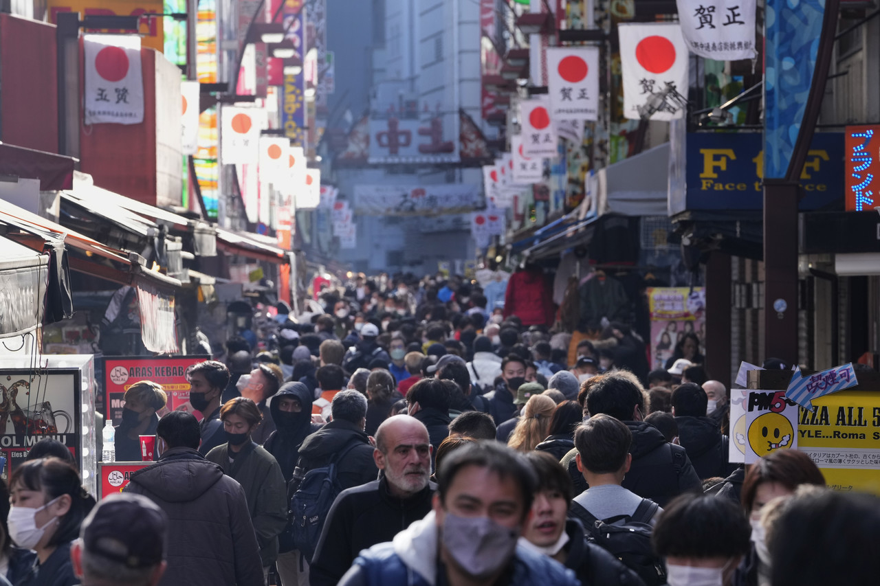 지난해 12월 30일 일본 도쿄에서 연말연시를 맞아 마스크 착용·미착용 시민들이 유명 쇼핑가에서 쇼핑하고 있다. 도쿄=AP