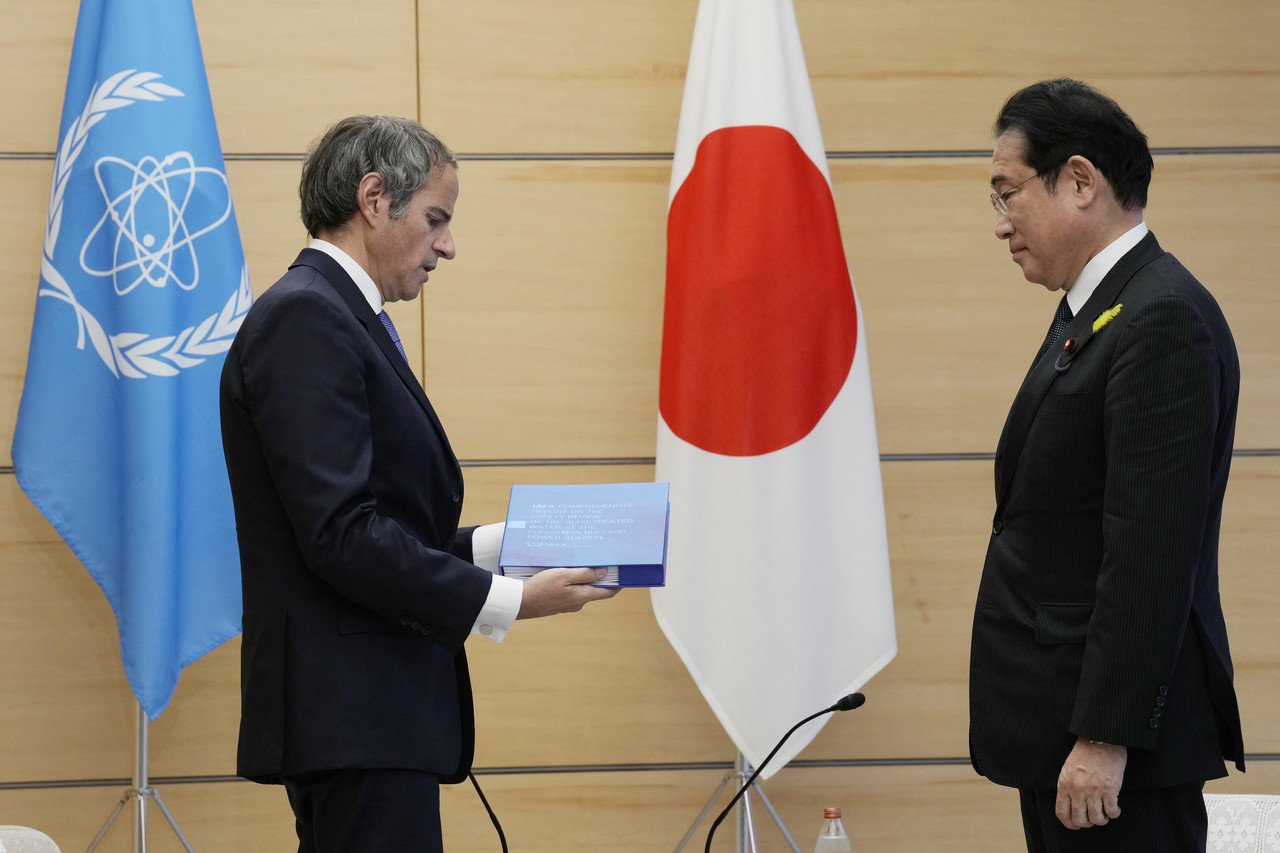 Rafael Mariano Grossi, Director General of the International Atomic Energy Agency, left, presents IAEA's report on Fukushima treated water release to Japanese Prime Minister Fumio Kishida at the prime minister's office Tuesday, July 4, 2023 in Tokyo. AP Photo