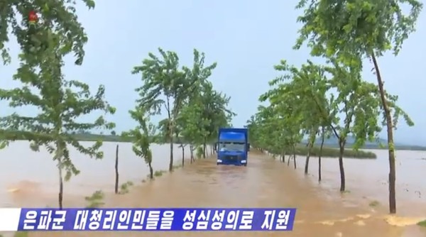 큰물 피해를 입은 북한 황해북도 은파군으로 양곡을 실은 트럭이 물살을 헤치며 가고 있다. 사진=조선중앙TV