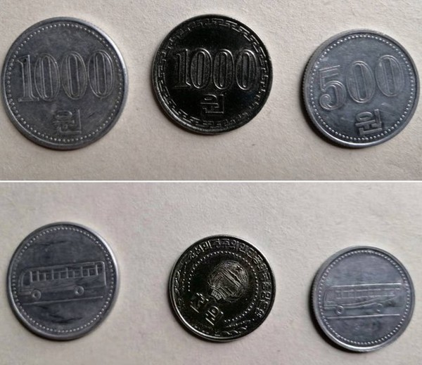 북한당국이 낡은 지폐 대신 내놓은 1000원짜리 은화(가운데) 동전. 사진=RFA